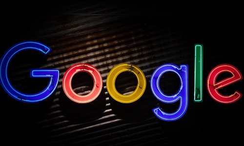Google logo in neon against a dark background