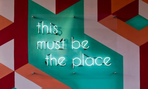 Neon sign that says "This must be the place"