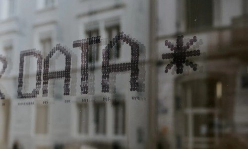 The word Data spelled in ASCII over a gray technical background