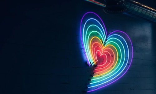 A rainbow heart in neon lights